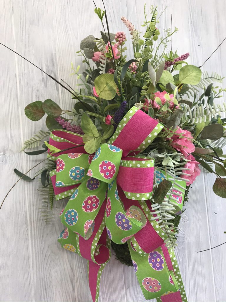 Designer spring decor made with faux flowers and greenery.