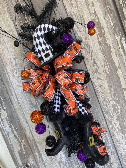 black pine branch with halloween ribbon and
