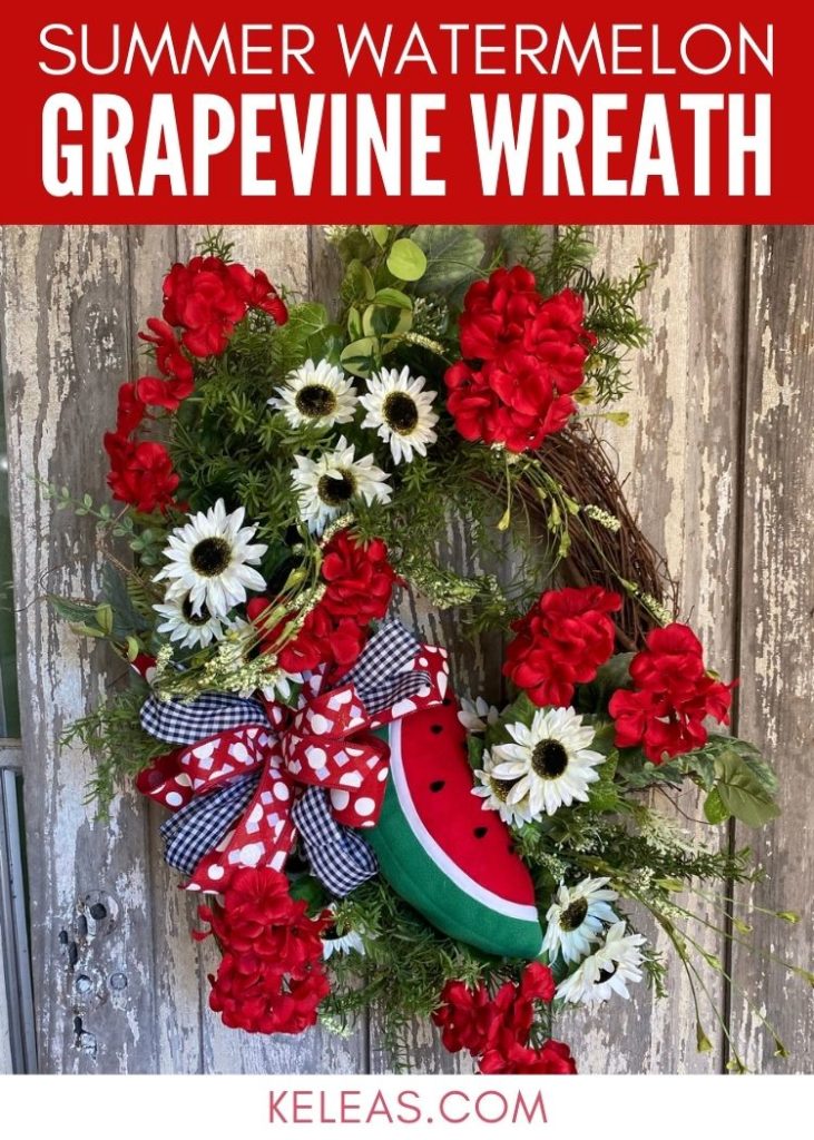 grapevine wreath with a plush watermelon and red geraniums and cream sunflowers