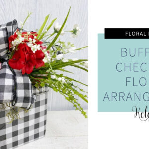black and white plaid tin with red flowers and greenery stems with a matching bow