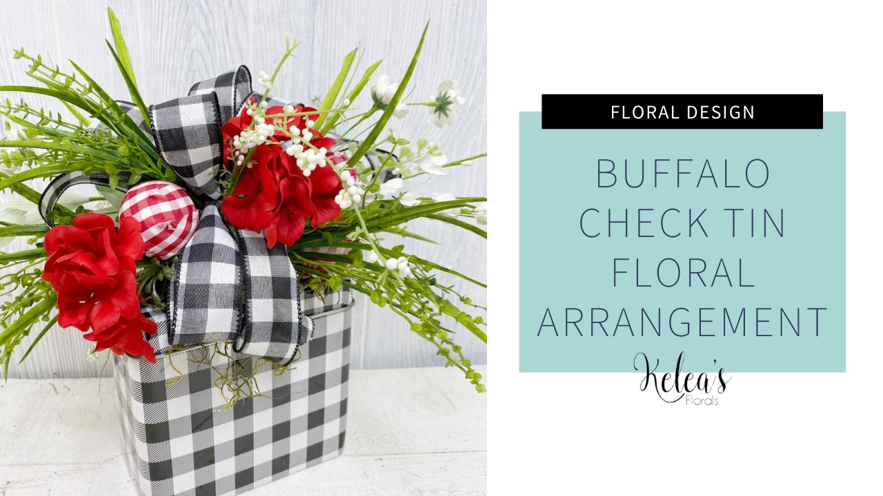 black and white plaid tin with red flowers and greenery stems with a matching bow