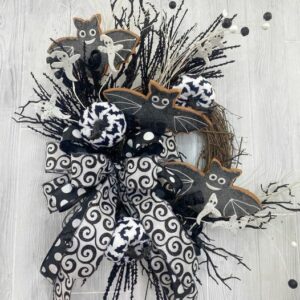 Black and white Halloween wreath with ghosts bats pumpkins and patterned ribbon