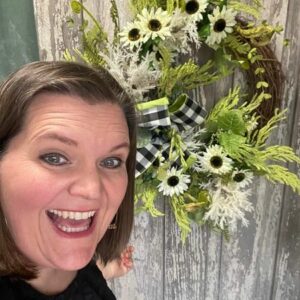 Kelea in front of White Sunflower Everyday Wreath from a BBBB box