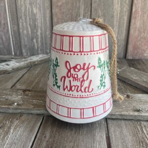 Red metal Ho Ho Ho Christmas bell with white lettering and decorative holiday details