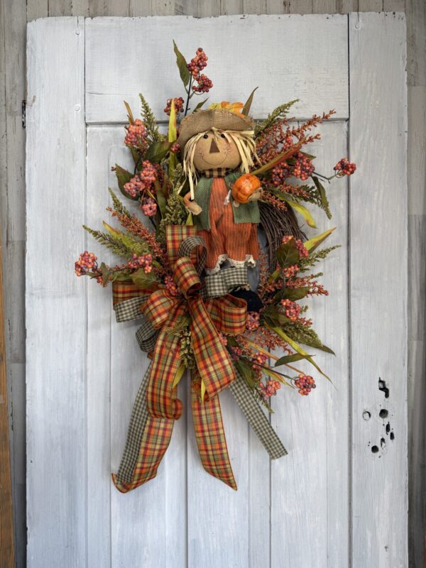 Fall scarecrow wreath with plaid ribbon and autumn greenery