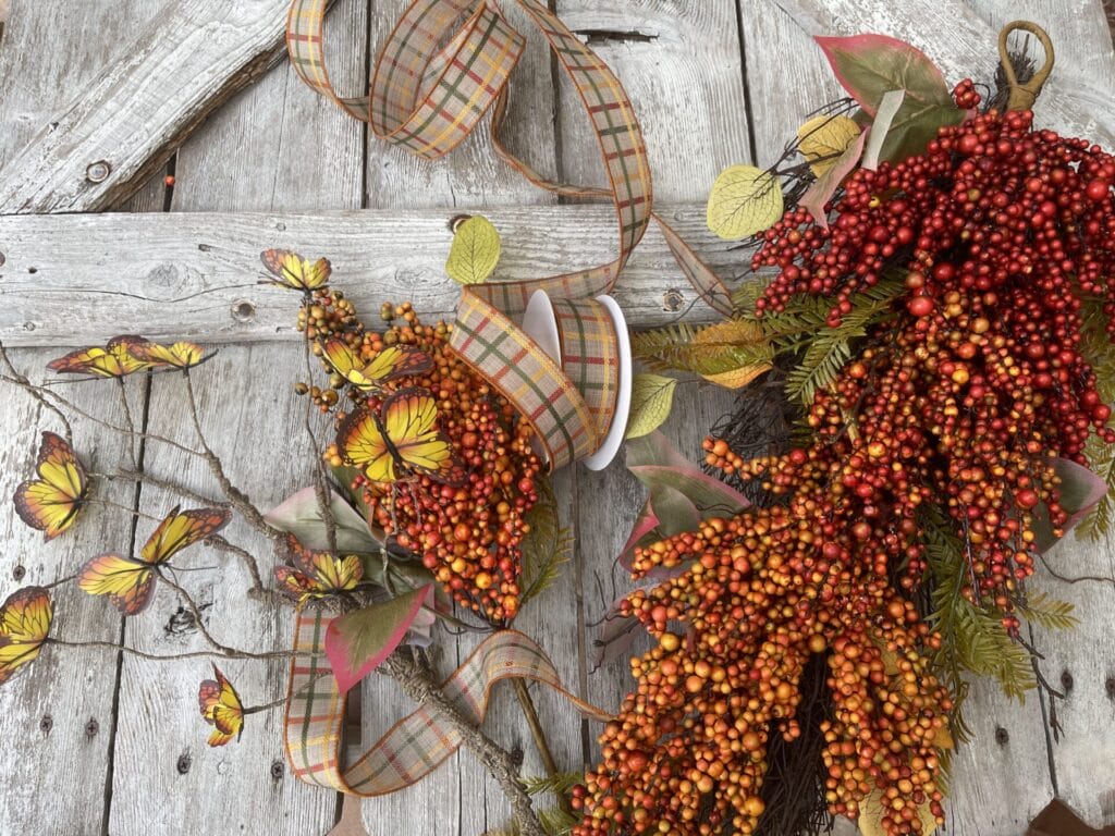 Berry swag with butterflies and ribbon in autumn textures and colors