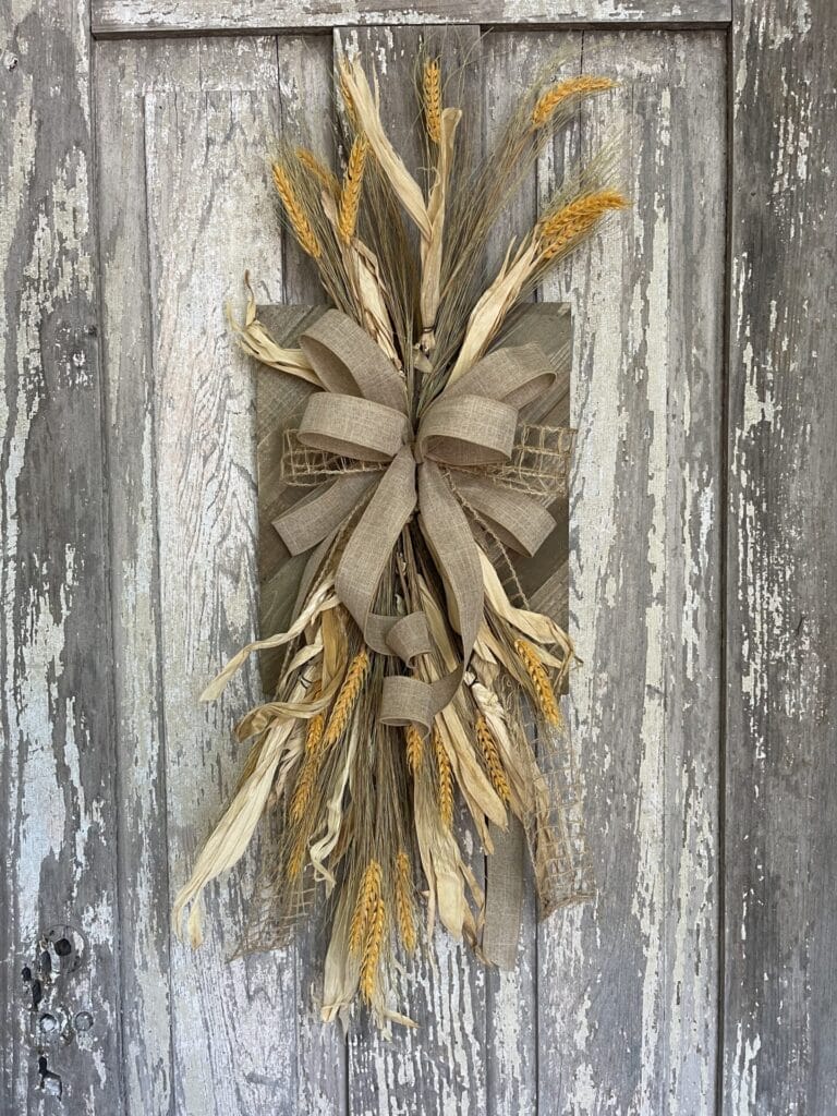Rustic wheat fall wall decor with corn husks and natural burlap bow