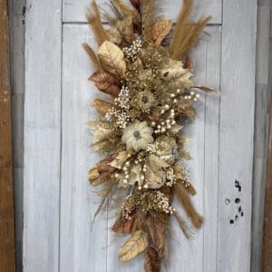 Autumn countryside swag with cream pumpkins brown leaves berries and wispy grasses