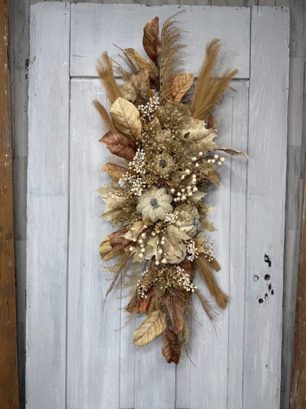 Autumn countryside swag with cream pumpkins brown leaves berries and wispy grasses