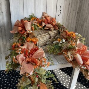 Fall pumpkin sunflower garland with autumn greenery and ribbon