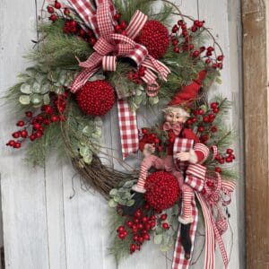 Christmas elf wreath with red berries greenery and red plaid ribbon