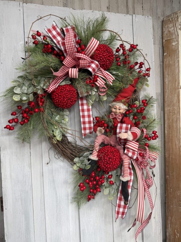 Christmas elf wreath with red berries greenery and red plaid ribbon