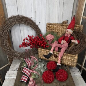 Christmas elf wreath supplies with red berries greenery ribbon and grapevine wreath