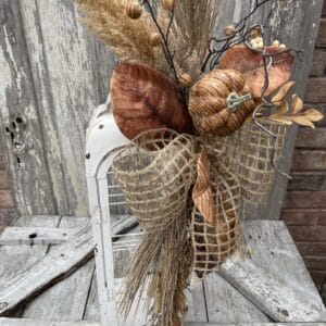 Rustic fall lantern swag with pumpkin, dried grasses, autumn leaves and natural ribbon