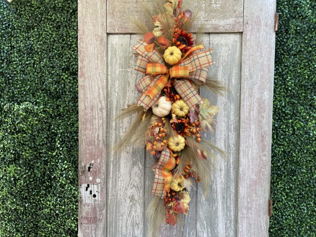 Fall pumpkin door swag with sunflowers, autumn plaid ribbon, berries and pumpkins