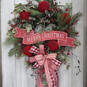 Red and white Merry Christmas wreath with berries and ribbon