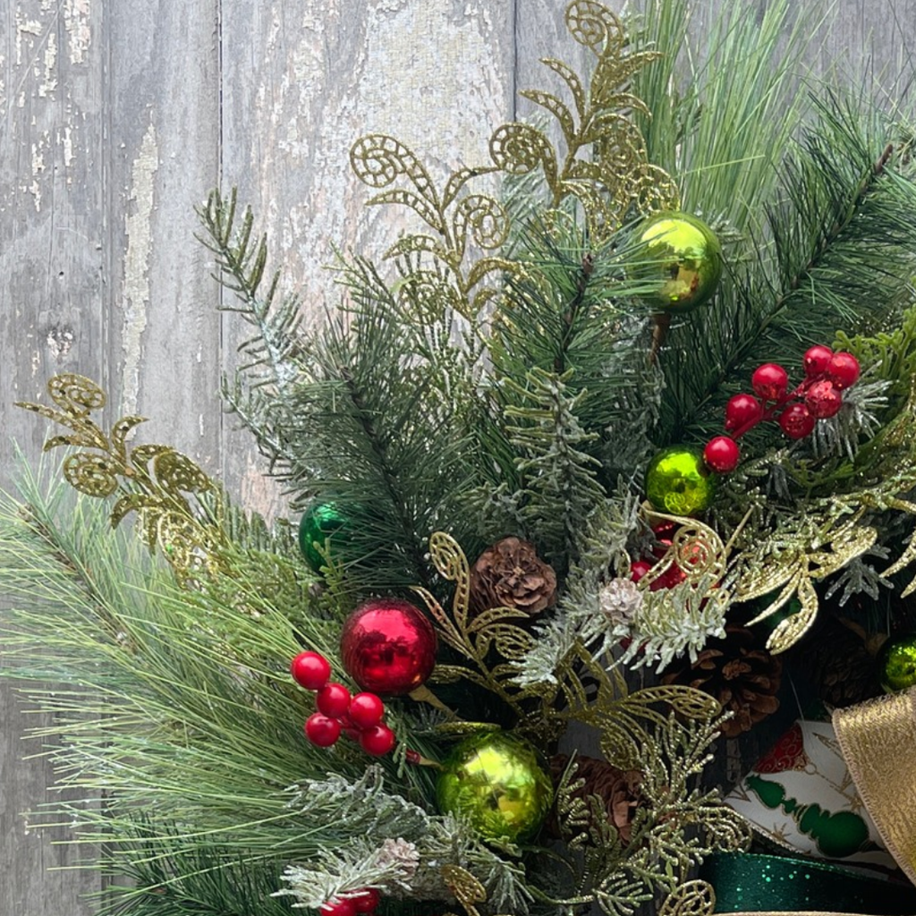 Layered iced pine and Christmas greenery on a vintage ornament wreath

