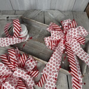Peppermint Twist Christmas bow with red and white candy cane striped ribbon, peppermint patterns and long tails