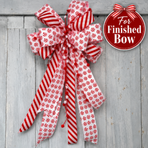 Handmade red and white peppermint Christmas bow with candy cane striped ribbon, pom pom accents, and long tails